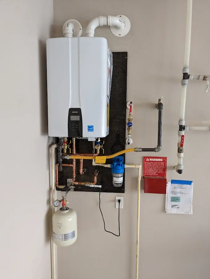 Professional plumber installing copper piping in a Perryville home